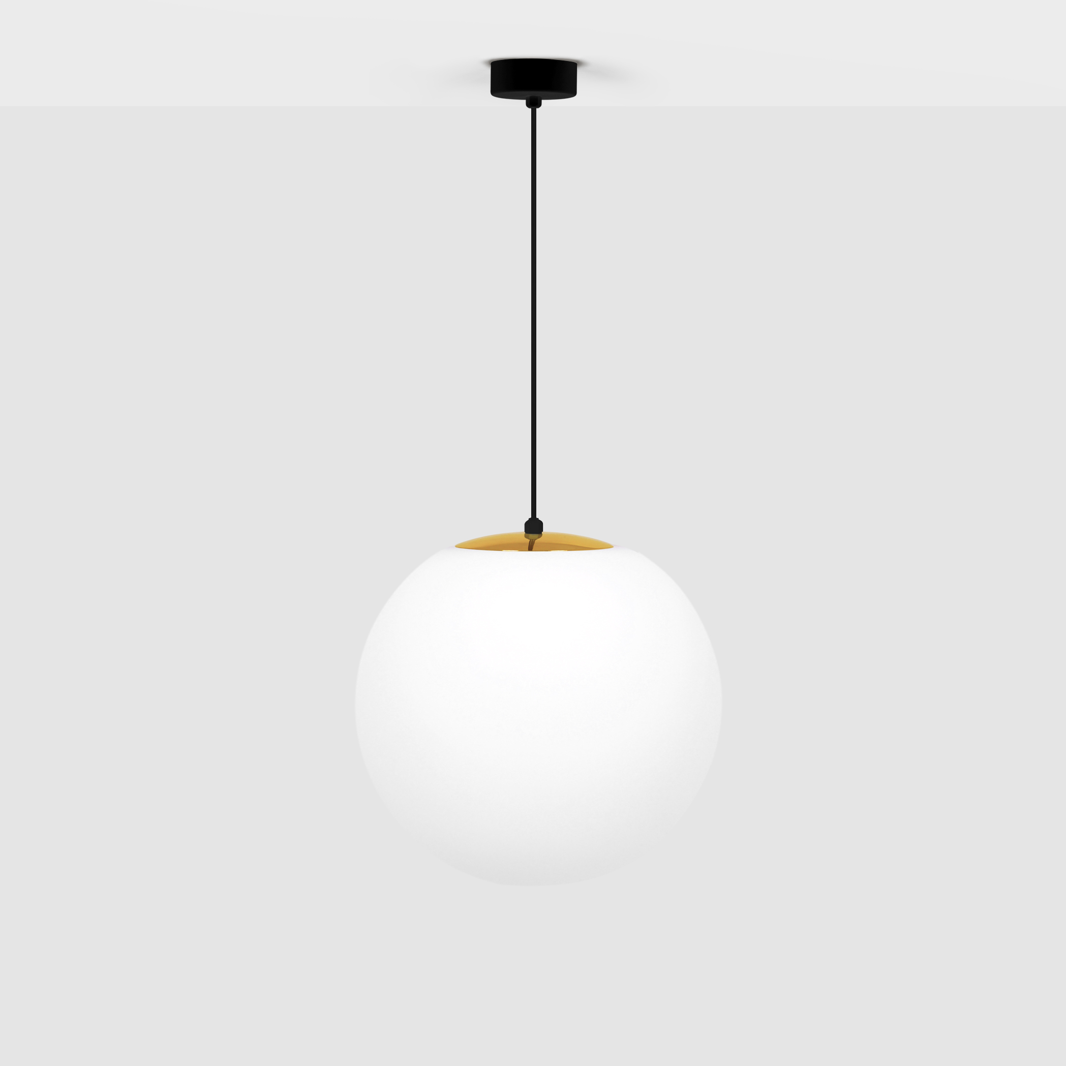 Lampa wisząca Isla D30 w kolorze czarnym z elementem w odcieniu patyny, z okrągłym kloszem z białego szkła. Zawieszona na cienkim czarnym kabelku, z widocznym mocowaniem sufitowym. Prosta, nowoczesna forma.