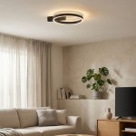 Czarna lampa sufitowa Arte z dwoma źródłami LED o mocy 30W, w kształcie okręgu z podświetleniem, zamontowana na suficie. Widoczna w nowoczesnym wnętrzu z sofą, rośliną i telewizorem.