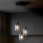 Lampa wisząca Silva 3xE27 w kolorze czarnym i grafitowym, z trzema szklanymi kloszami o żłobionej fakturze, zawieszona na metalowych linkach. Ujęcie z góry, w minimalistycznym wnętrzu, na tle ciemnej zabudowy.