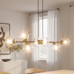 Lampa wisząca Rossi 6-punktowa w kolorze czarnym i transparentnym, z sześcioma okrągłymi kloszami, zawieszona na długich kablach. Zbliżenie na źródła światła, w tle jasne wnętrze z roślinnością i zasłonami.