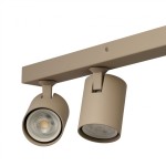 Beżowa lampa sufitowa spot Exo Line z czterema oprawami GU10. Ujęcie z góry, ukazuje dwa cylindryczne klosze zamontowane na prostokątnej podstawie, z widocznymi żarówkami. Prosta konstrukcja idealna do nowoczesnych wnętrz.