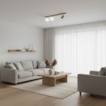 Beżowa lampa sufitowa Aspa K-5830 z jednym gniazdem GU10 i dwoma gniazdami G9. Zainstalowana na prostym stelażu, z dwoma okrągłymi kloszami, w jasnym wnętrzu, nad szarym sofą i drewnianym stolikiem.