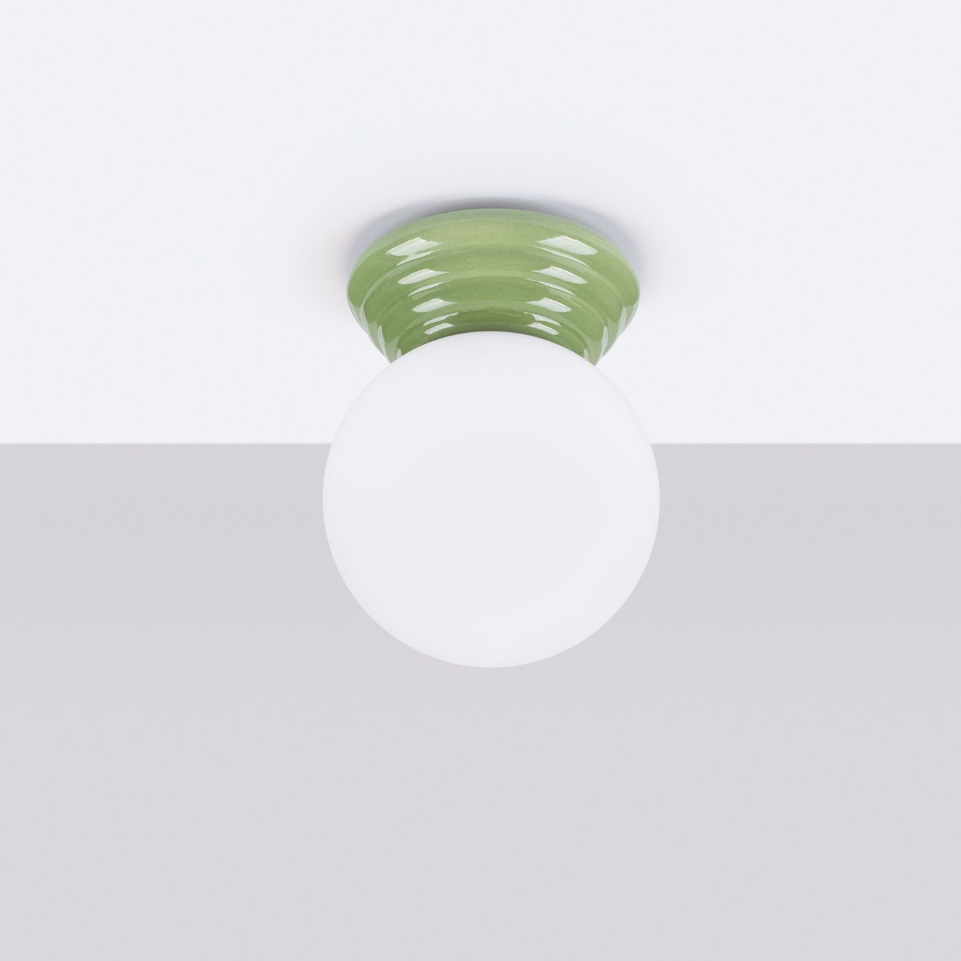 Zori lampa sufitowa 1xG9 IP44 w zielonym kolorze z okrągłym, białym kloszem. Zamontowana na suficie, z widoczną, teksturowaną podstawą. Idealna do wnętrz, oferująca nowoczesny design.