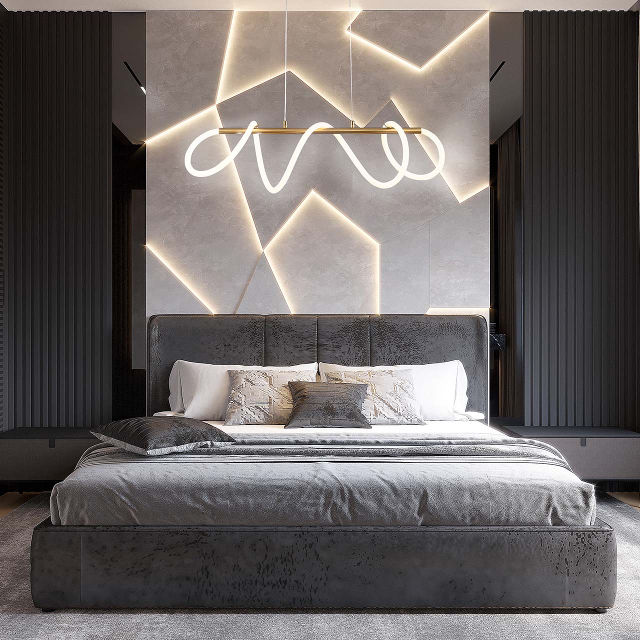 Lampa wisząca LED Emma o mocy 85W i barwie światła 4000K w kolorze złotym, zawieszona nad łóżkiem w nowoczesnej sypialni. Widoczny stylowy kształt z falującymi liniami, w otoczeniu minimalistycznego wnętrza z szarymi ścianami.