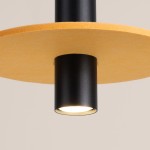 Lampa wisząca Pelta 1xGU10 w kolorze czarnym z żółtym kloszem. Widok z bliska, ukazujący cylindryczny korpus z matowego metalu oraz okrągły, żółty element. Idealna do nowoczesnych wnętrz.