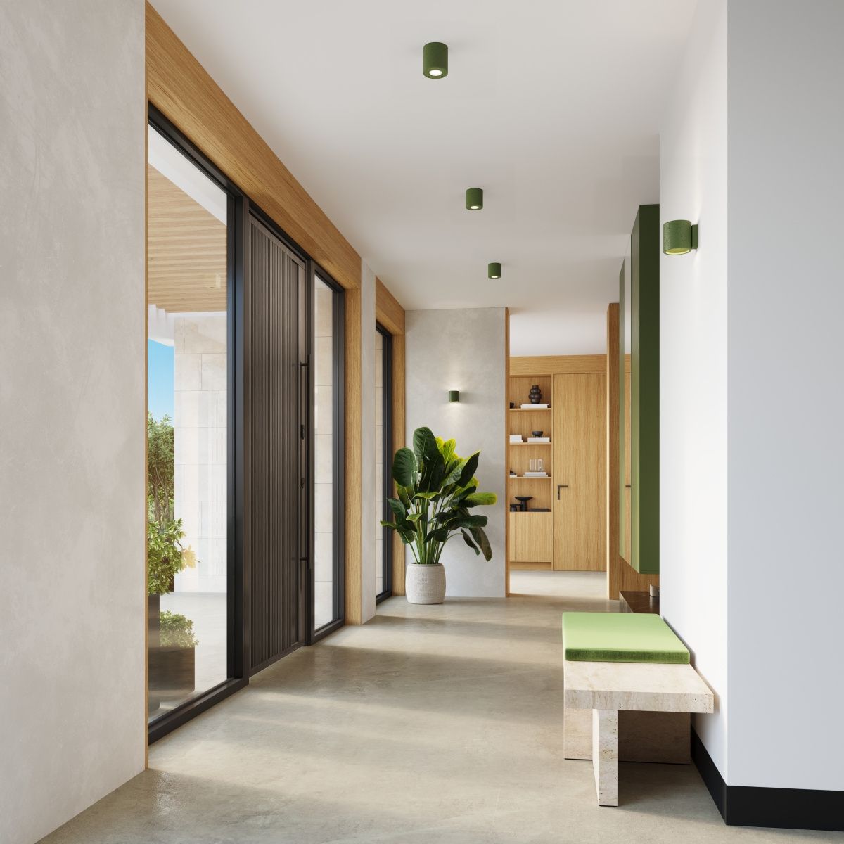 Lampa sufitowa Orbis Beton 1xGU10 w kolorze zielonej oliwki, zamontowana na suficie w nowoczesnym wnętrzu. Widoczna w przestronnym korytarzu z drewnianymi detalami i roślinnością, podkreślająca minimalistyczny styl aranżacji.