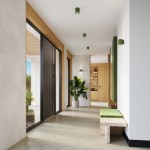 Lampa sufitowa Orbis Beton 1xGU10 w kolorze zielonej oliwki, zamontowana na suficie w nowoczesnym wnętrzu. Widoczna w przestronnym korytarzu z drewnianymi detalami i roślinnością, podkreślająca minimalistyczny styl aranżacji.