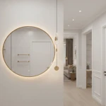 Lampa wisząca LED Sunblast 5W 3000K w złotym kolorze, zawieszona na cienkim kabelku, obok okrągłego lustra. Lampa ma subtelny, nowoczesny design, idealna do wnętrz. Tło w jasnych odcieniach, w aranżacji z eleganckim wystrojem.