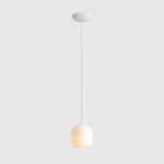 Kremowa lampa wisząca Flask Cotton D18 z kloszem w kształcie prostopadłościanu, zawieszona na cienkim, białym kablu. Źródło światła E14. Tło w jednolitym, jasnoszarym kolorze.