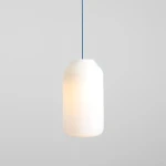 Lampa wisząca Flask Sapphire D19 w kształcie cylindrycznym, z białego szkła, zawieszona na niebieskim przewodzie. Zewnętrzna powierzchnia gładka, emitująca miękkie światło, idealna do nowoczesnych wnętrz. Tło proste, szare.