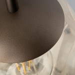 Lampa wisząca Lava Brown D25 w kolorze brązowym z mocowaniem E27. Zbliżenie na metalowy, matowy klosz o okrągłym kształcie z fakturą, zawieszony na cienkim pręcie. Widoczne wnętrze z żarówką w ciepłym odcieniu.