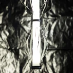 Lampa wisząca LED Elva 22W 3000K w kolorze czarnym/grafitowym. Owalny, szklany klosz z teksturą, z wbudowanym źródłem światła. Ujęcie z dołu, z bliska, na tle ciemnego materiału.