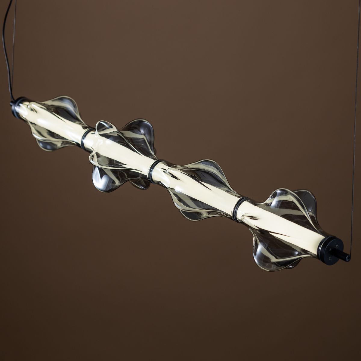 Lampa wisząca LED Elva 30W, kolor czarny/grafitowy, z przezroczystymi, falującymi kloszami. Ujęcie z boku, z widoczną żarówką LED. Elegancki design, idealna do nowoczesnych wnętrz.