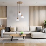 Lampa wisząca Ballo w kolorze beżowym, z trzema kloszami w kształcie sześcianu, zawieszona na cienkich przewodach. Elementy drewniane na górze kloszy. Produkt umieszczony nad jasną sofą w nowoczesnym wnętrzu.