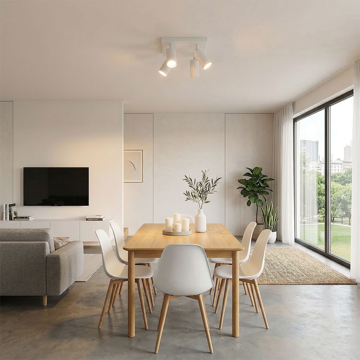 Lampa sufitowa Spoti SQ w kolorze białym z czterema reflektorami GU10, zamontowana na suficie w nowoczesnym wnętrzu. W tle widoczna jadalnia z drewnianym stołem i białymi krzesłami.