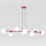 Lampa wisząca Magnus 8xE14 w kolorze burgundowym z białymi kulistymi kloszami. Produkt zawieszony na dwóch cienkich linkach, z okrągłą podsufitką. Klosze rozmieszczone asymetrycznie na metalowej ramie, nadając unikalny wygląd. Tło proste, białe.