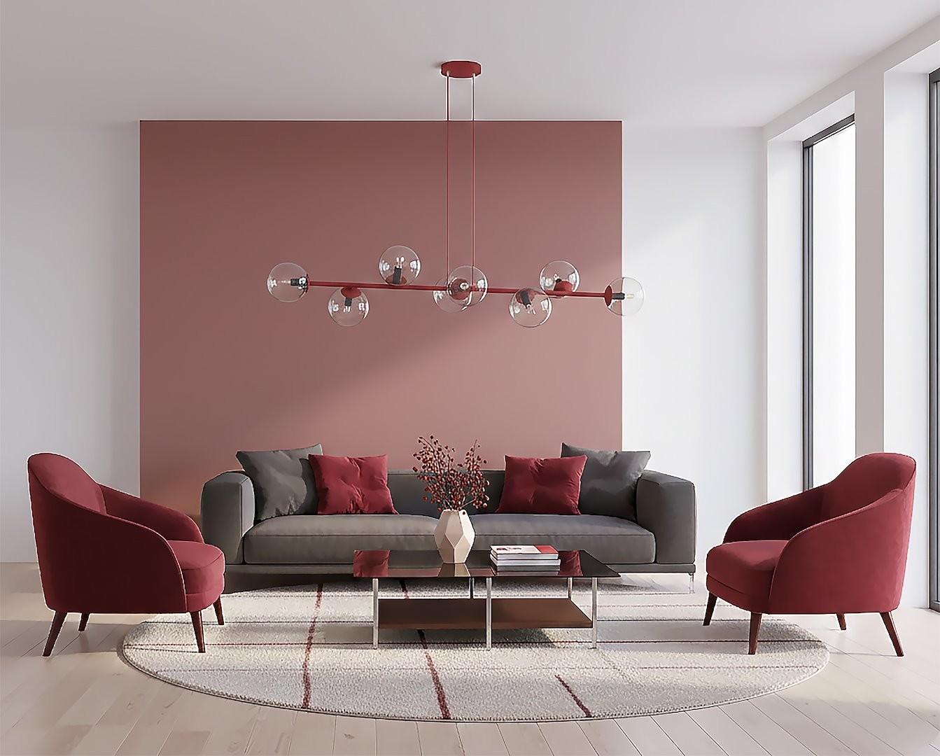 Lampa wisząca Magnus 8xE14 w kolorze burgundowym z transparentnymi kloszami, montowana na suficie, w nowoczesnym wnętrzu z szaro-burgundową kanapą i okrągłym dywanem. Widać również dwa czerwone fotele i stół kawowy.