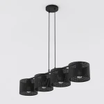 Lampa wisząca Lux 1670/4 z czterema abażurami w formie perforowanych cylindrów, zawieszona na czarnych linkach. Abażury są otwarte u dołu, co umożliwia wykorzystanie żarówek E27. Całość montowana do sufitu, na jednolitym tle.