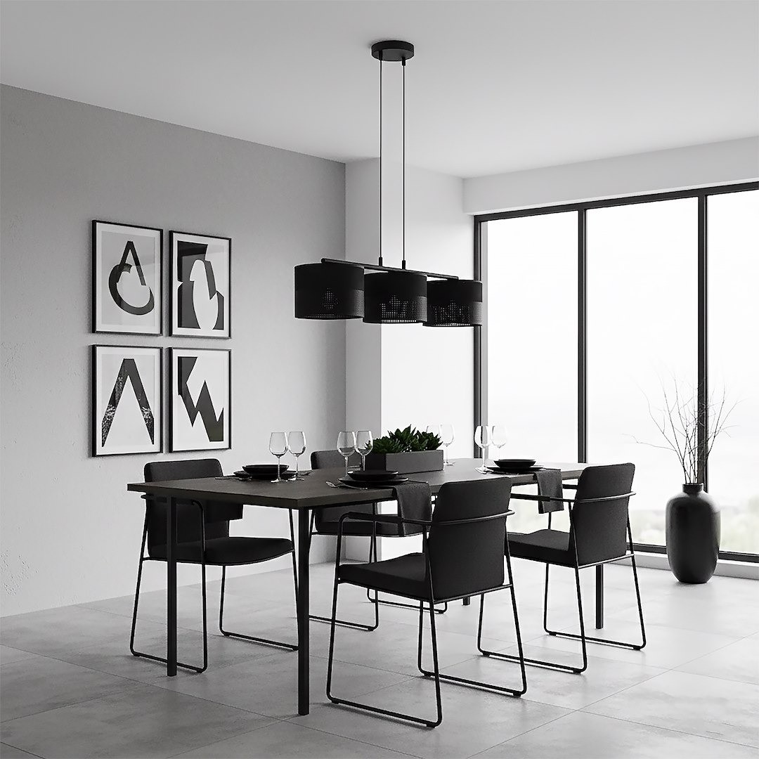 Lampa wisząca Karbon 3xE27 w kolorze czarnym, z trzema cylindrycznymi kloszami, zawieszona nad stołem w nowoczesnej jadalni. Ujęcie z boku, w tle prostokątne okno oraz minimalistyczne dekoracje na ścianach.