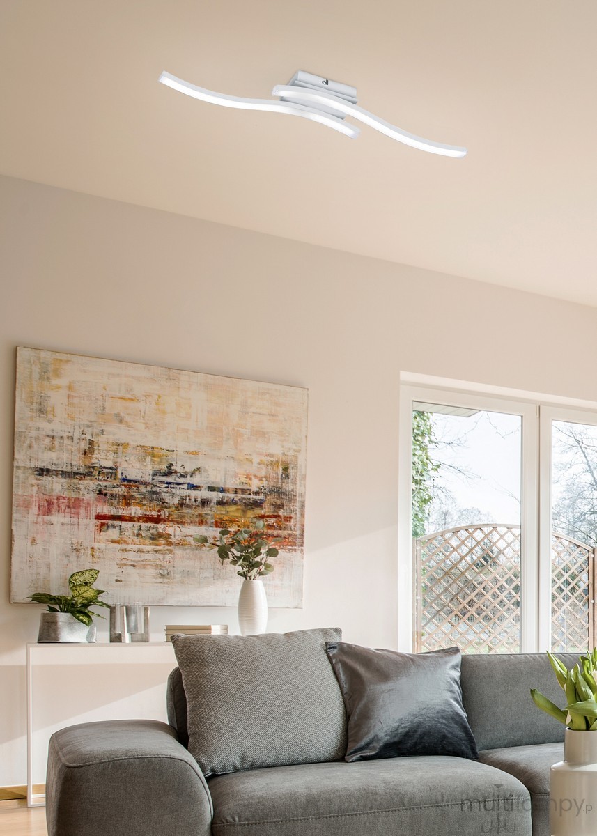 Biała lampa sufitowa Route LED 4000K z dwoma falistymi elementami. Ujęcie z góry, zamontowana na prostokątnej podstawie. Prosty, nowoczesny design, idealna do oświetlenia wnętrza. Tło w odcieniu szarym.