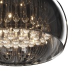 Duża lampa sufitowa Crystal, 6-punktowa, o okrągłej, przezroczystej obudowie z elementami szklanymi. Widoczne eleganckie kryształki w górnej części, emitujące światło. Ujęcie z góry, ukazujące detale i fakturę lampy.