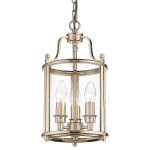 Lampa wisząca New York 3-punktowa w kolorze złotym, o cylindrycznym kształcie, z przezroczystymi ściankami i trzema źródłami światła w kształcie łzy. Zawieszona na łańcuchu, pełni funkcję eleganckiego oświetlenia.