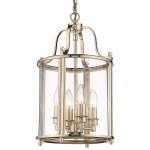Lampa wisząca New York 4-punktowa w złotym kolorze, z przezroczystym kloszem, zawiera cztery żarówki w stylu świecy. Kształt cylindryczny, z metalową ramą, zawieszona na łańcuchu. Wysoka jakość wykonania, elegancki design.