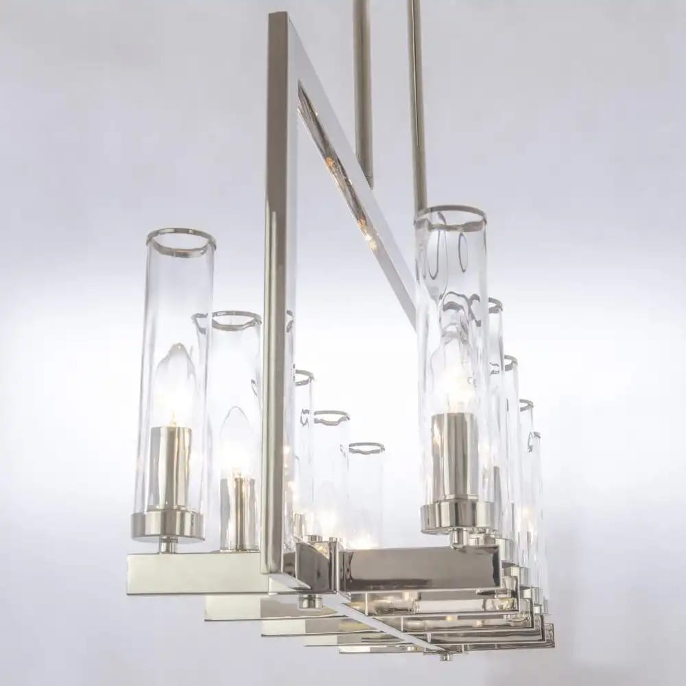 Lampa wisząca Oxford 10-punktowa P10069NI, z chromowanej stali, z przezroczystymi szklanymi kloszami. Ujęcie z boku, ukazujące elegancki design i źródła światła, zawieszona na długich linkach w minimalistycznym stylu. Tło jasne.