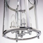 Lampa wisząca New York 4-punktowa P04550CH w chromowanej obudowie, z przezroczystymi szklanymi panelami. Widoczne cztery źródła światła w kształcie kropli, umieszczone w okrągłej podstawie. Ujęcie z dołu, eksponujące detale konstrukcji.