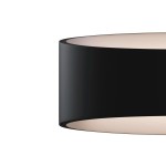 Kinkiet Trame LED w kolorze czarnym, o cylindrycznym kształcie. Materiał matowy, z białym wnętrzem. Produkt widoczny z boku, podkreślający minimalistyczny design. Idealny do nowoczesnych wnętrz.