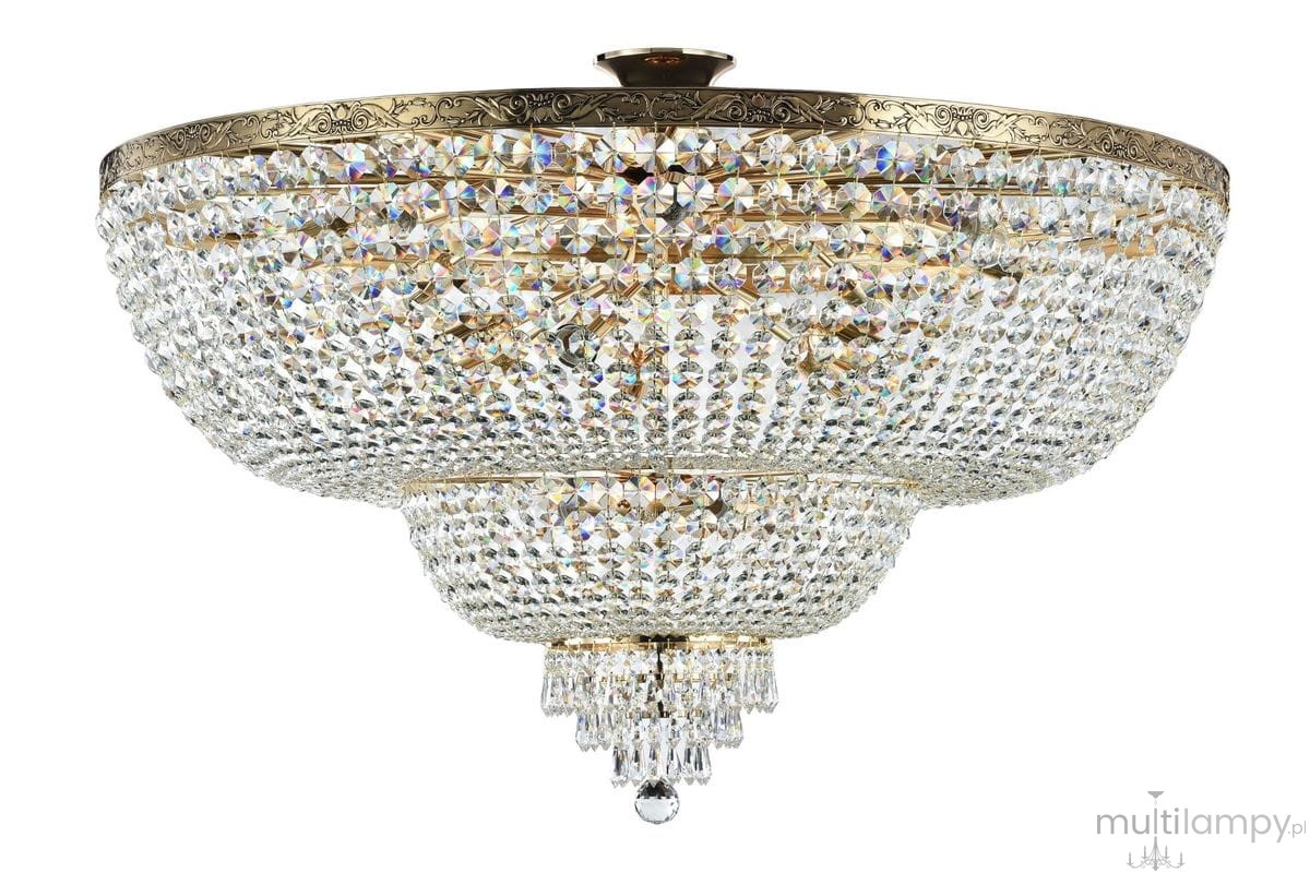 Lampa sufitowa Palace 18-punktowa w kształcie okrągłym, z przezroczystymi kryształkami. Górna część złota z dekoracyjnym wzorem, dolna z wiszącymi kryształkami. Całość lśniąca, umieszczona w pozycji wiszącej.