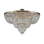 Lampa sufitowa Palace 14-punktowa, okrągła, zdobiona kryształami, w kolorze przezroczystym. Metalowa, złota oprawa z dekoracyjnym brzegiem. Zawieszona w pozycji wiszącej, z efektownymi detalami w postaci zwisających kryształów.