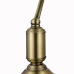 Lampka stołowa Kiwi Z153-TL-01-BS w kolorze antycznego złota, z metalowym, cylindrycznym korpusem i dekoracyjnym wykończeniem. Ujęcie w zbliżeniu na detal podstawy, z charakterystycznym kształtem i gładką powierzchnią.