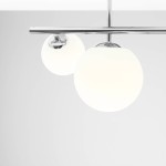 Lampa sufitowa Dione 3-punktowa w kolorze chromu z dwoma białymi, okrągłymi kloszami z mlecznego szkła. Ujęcie z góry, ukazujące detale konstrukcji oraz przezroczystość kloszy. Zawieszona na prostym stelażu.