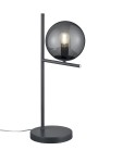 Lampa stołowa Pure 1-punktowa w kolorze antracytowym, z okrągłym kloszem w odcieniu szaro-przezroczystym. Stojąca na okrągłej podstawie, z cienką, prostą nogą oraz poprzeczką. Widoczna żarówka wewnątrz klosza.