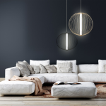 Czarna lampa wisząca Treviso LED D40 o jednolitym kształcie, z delikatnym źródłem światła, zawieszona nad białą sofą. Lampa emituje światło o temperaturze barwowej 4000K, tworząc nowoczesny akcent w aranżacji wnętrza.