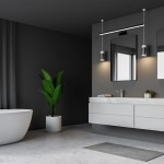 Czarny kinkiet Shine LED IP44 1-punktowy, o wymiarach L80/15W, zamontowany na ścianie w łazience. W tle widoczna szafka z umywalką, lustra oraz roślina w doniczce. Oświetlenie podkreśla nowoczesny styl wnętrza.