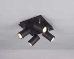 Czarna lampa sufitowa typu spot z czterema cylindrycznymi reflektorami, zamocowana na kwadratowej podstawie. Reflektory mają złote detale wewnętrzne i są ustawione pod różnymi kątami, co pozwala na regulację kierunku światła.