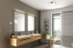 Kinkiet Mattimo LED w kolorze chromu, o wymiarach L60 cm i mocy 6,5W, zamontowany na ścianie w łazience. Posiada okrągłą głowicę, skierowaną na lustrzane odbicie. W otoczeniu drewnianej szafki z umywalką i nowoczesnym wystrojem wnętrza.