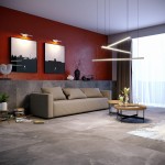 Trio LED lampa wisząca ściemnialna, czarna, z trzema punktami świetlnymi, zawieszona nad stolikiem w nowoczesnym wnętrzu. W tle czerwona ściana z obrazami oraz szary zestaw wypoczynkowy. W pomieszczeniu duże okno z zasłonami.