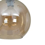Lampa wisząca Sofia 1-punktowa w kolorze bursztynowym, o okrągłym kształcie. Wykonana z przezroczystego szkła, z widoczną żarówką wewnątrz. Ujęcie z góry, podkreślające gładką powierzchnię i lekko zaokrąglone krawędzie.
