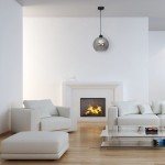 Lampa wisząca Sofia 1-punktowa z dymionego szkła, umieszczona na czarnym przewodzie, w nowoczesnym wnętrzu z jasnymi meblami. W tle widoczny kominek i szklany stół.