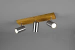 Lampa sufitowa Marley 3-punktowa z drewnianą podstawą w kolorze jasnego brązu i trzema metalowymi reflektorami w kolorze niklu. Reflektory są cylindryczne, montowane na ruchomej podstawie. Ujęcie z góry, na jednolitym szarym tle.