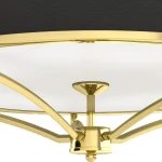 Złota lampa sufitowa Stesso Gold Nero S z czarnym abażurem, czteropunktowa. Widok z dołu, ukazujący złote ramiona i okrągłą, białą osłonę. Elegancki design z metalowymi detalami, idealna do nowoczesnych wnętrz.