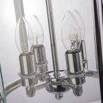 Lampa wisząca New York 4-punktowa P04550CH z chromowanym wykończeniem, cztery żarówki w kształcie łzy umieszczone w metalowych oprawach, z widocznym okrągłym mocowaniem. Tło jasne, proste.